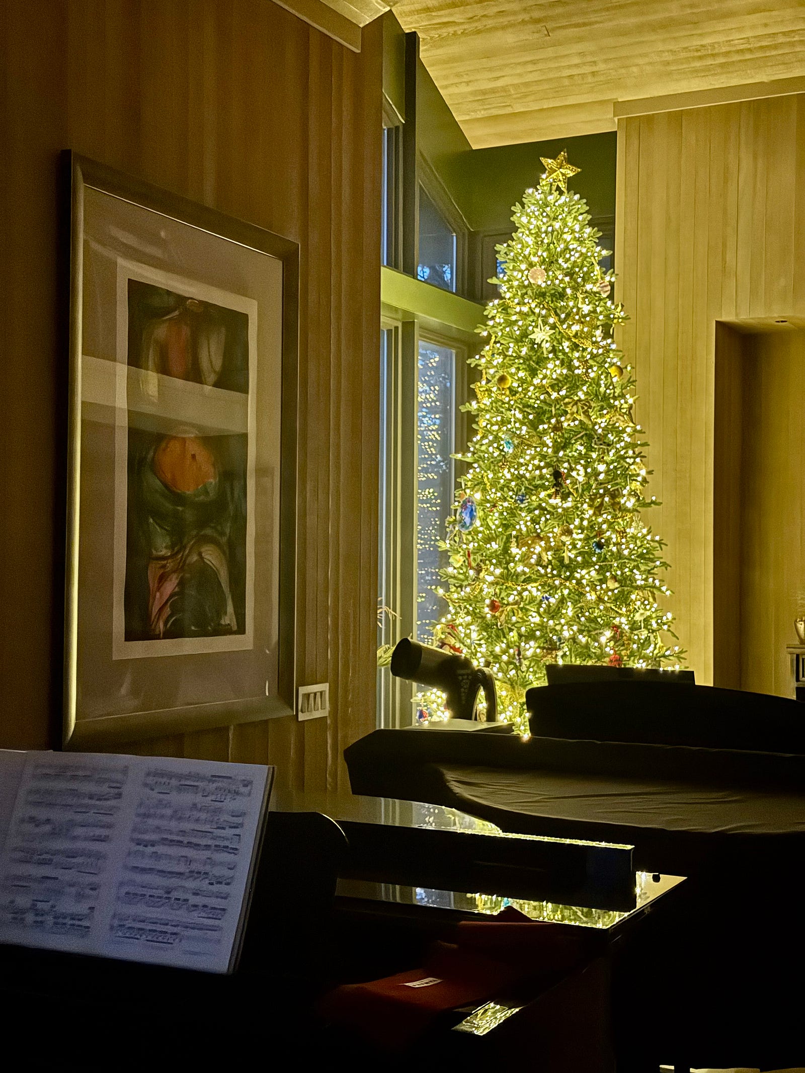 Two nestled grandpianos are in the foreground, with a large well-lit Christmas tree in the background. The piano is a very safe zone for me. I always feel less stressed after being immersed in learning a new piece. Sight-reading requires focus (and removal from the outside world), a form of mindfulness.