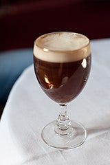Irish coffee. The caffeine source is coffee, with 80 milligrams per drink (48 mg/100 mL).