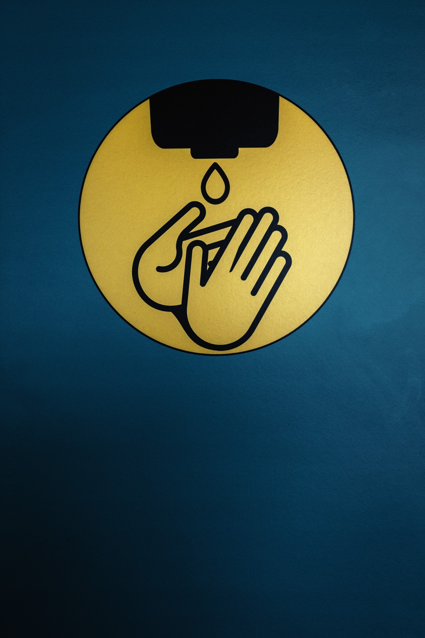 Cartoon of two hands under a drop of water.