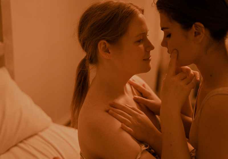 topless woman lying on bed