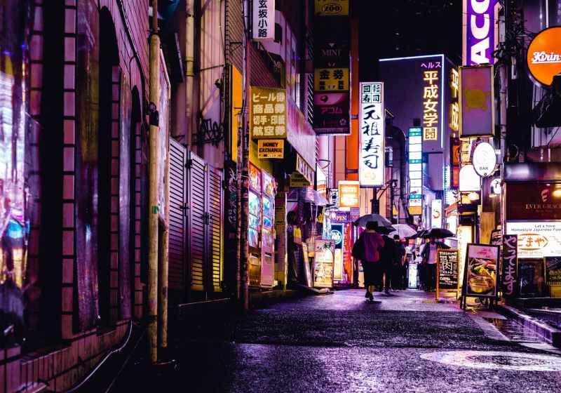 woman walking in the street during night time