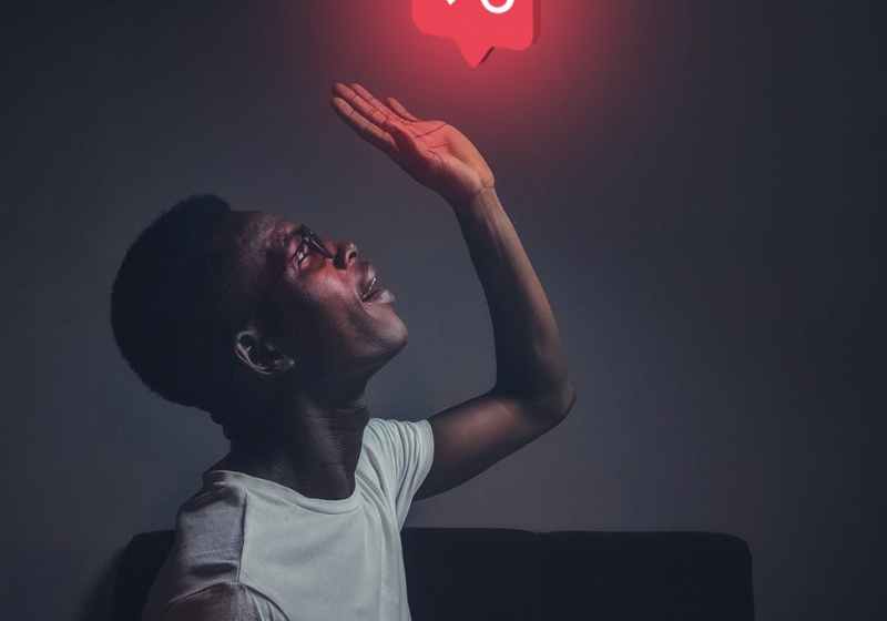 man in white crew neck top raising hi left hand