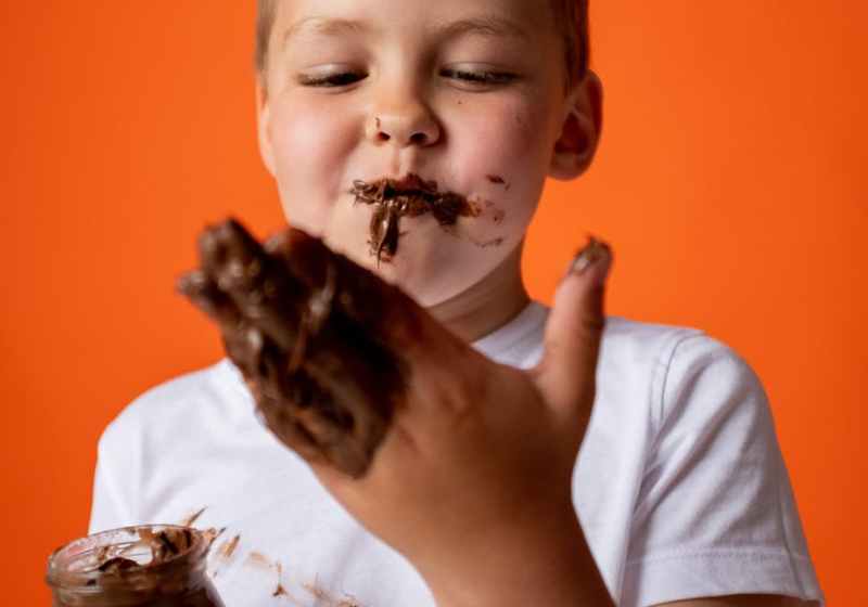 photo of boy enjoying melted chocolate
