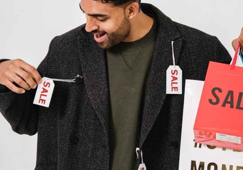 man in gray blazer with sale tags