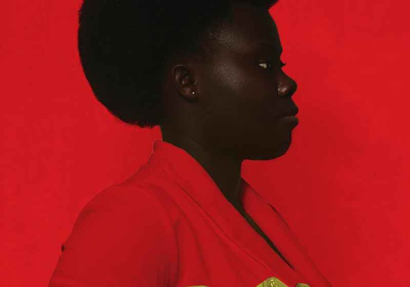 black woman with handbag on red background