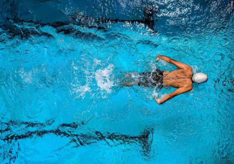person swimming on body of water