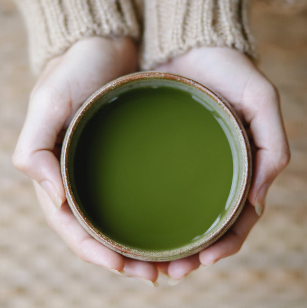 woman demonstrating bowl with traditional green tea