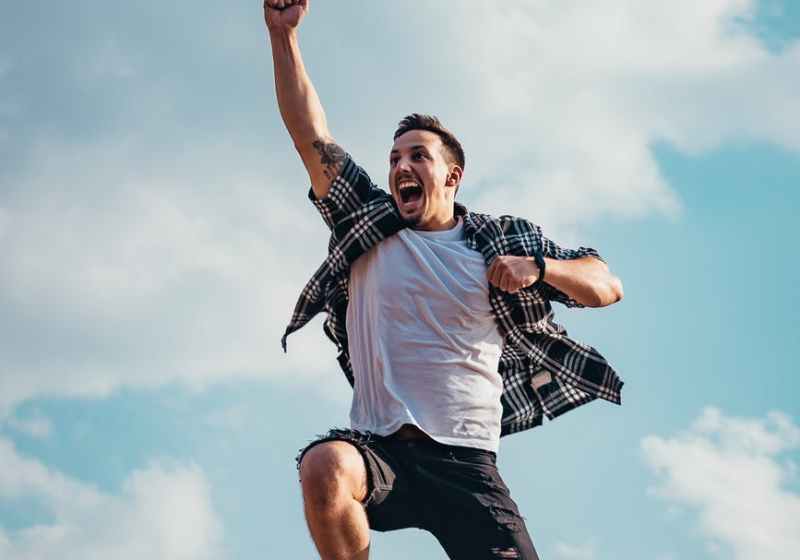 low angle photography of man jumping