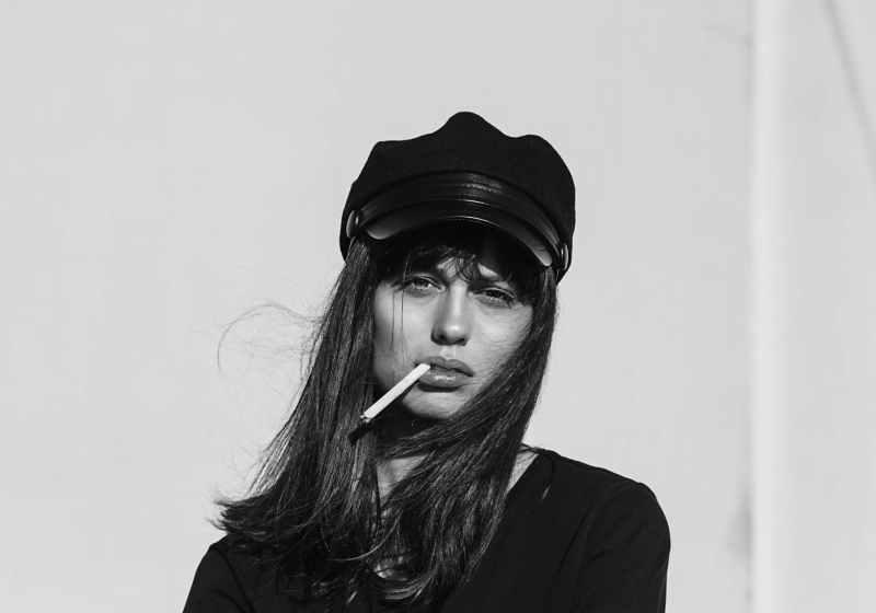 woman wearing black top while smoking