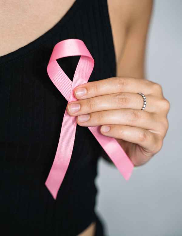 pexels-photo-5482993 woman in black tank top holding pink ribbon