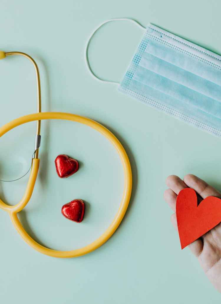 medical stethoscope and mask composed with red foiled chocolate hearts