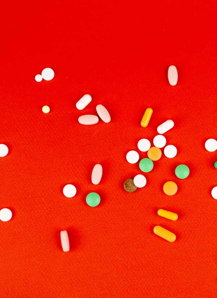 medications on red surface