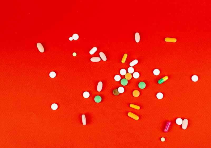 medications on red surface