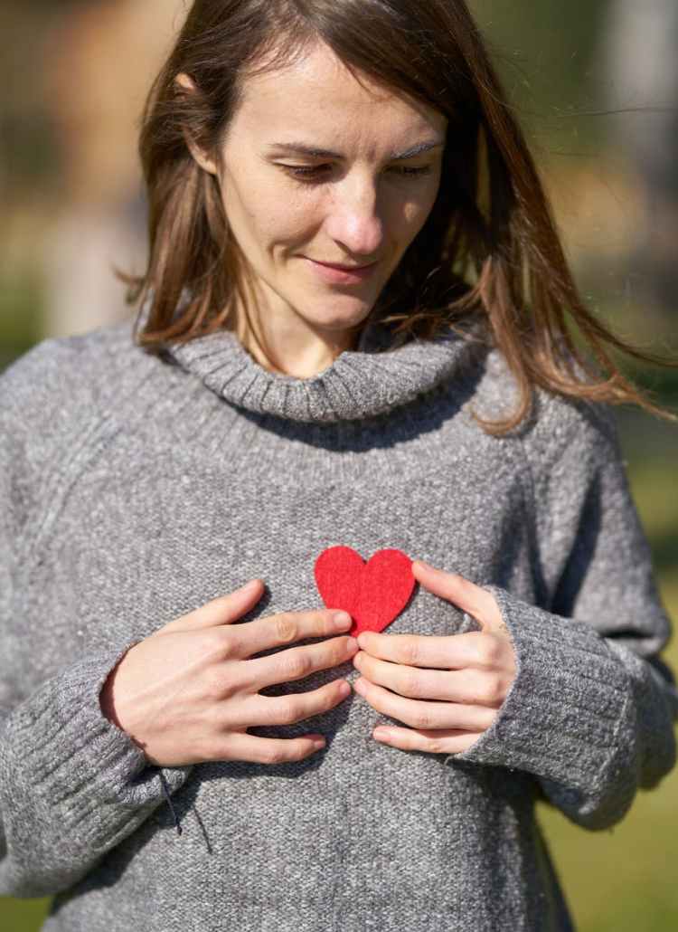 woman holding heart cut out
