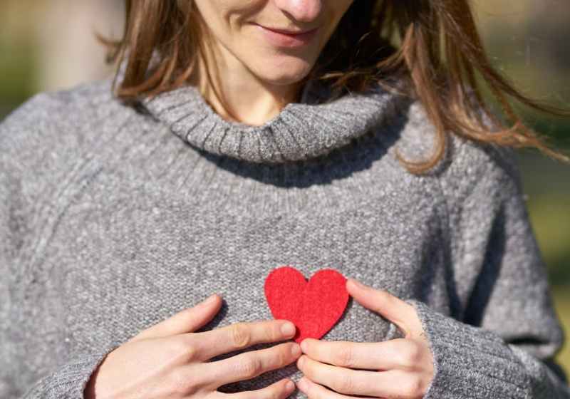woman holding heart cut out