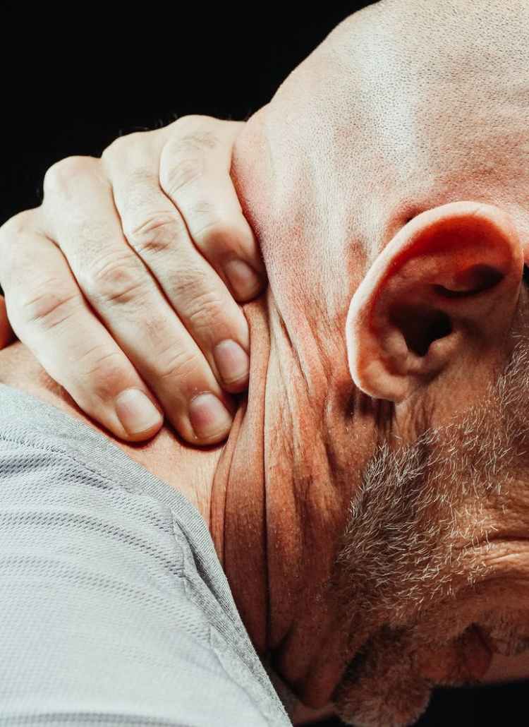 close up photo of a man having a neck pain