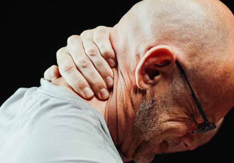 close up photo of a man having a neck pain