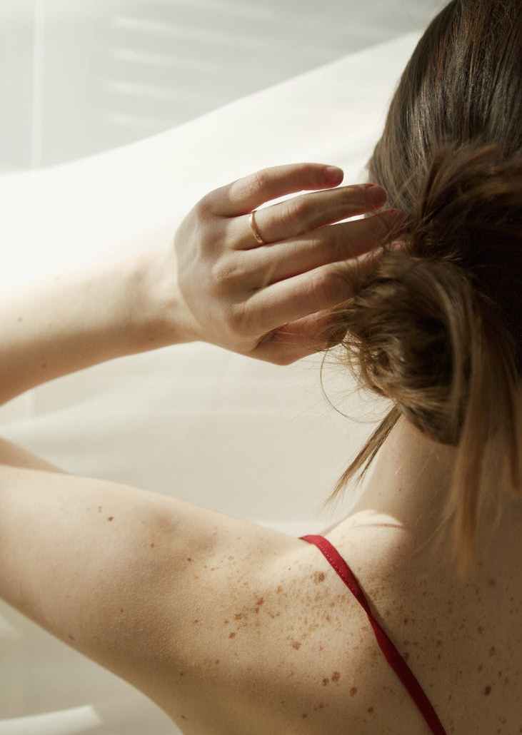 a woman touching her hair