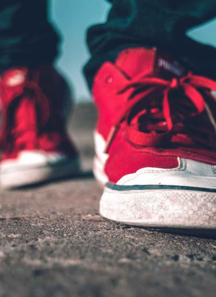 photo of person wearing red shoes