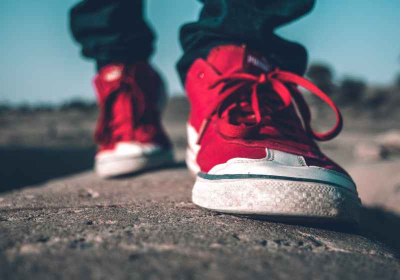 photo of person wearing red shoes