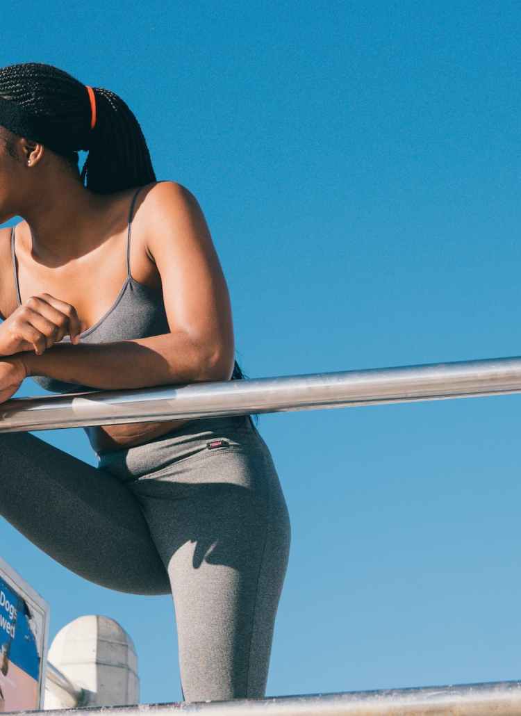 woman in black tank top and gray leggings