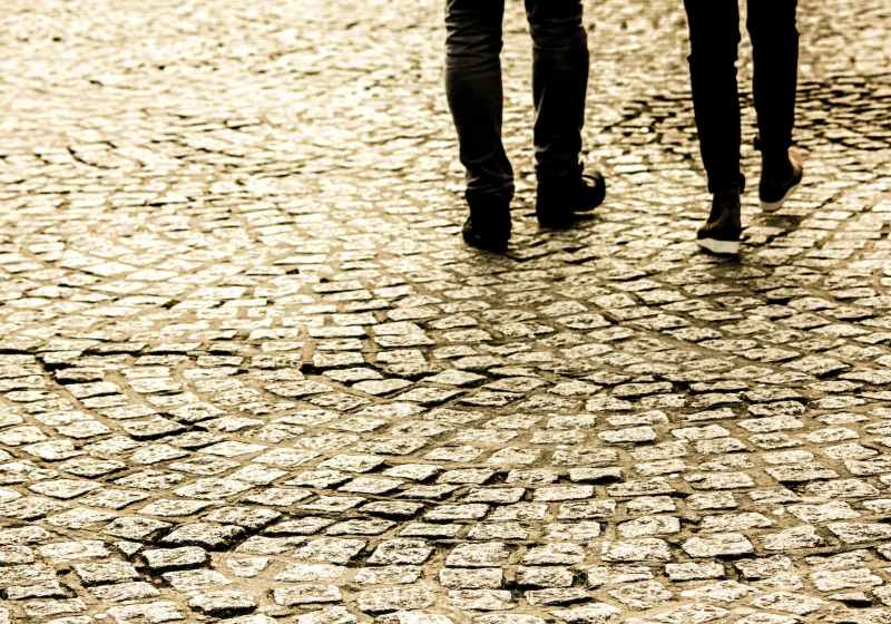 person waling on concrete bricks road