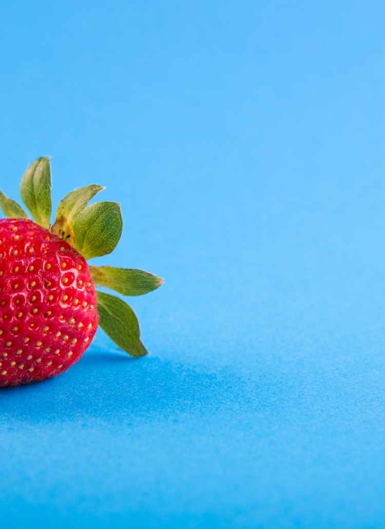 strawberry on blue surface