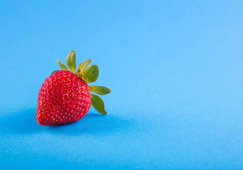 strawberry on blue surface