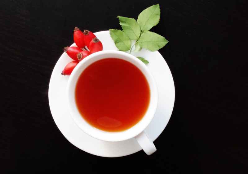 white cup filled with orange liquid on top of white saucer