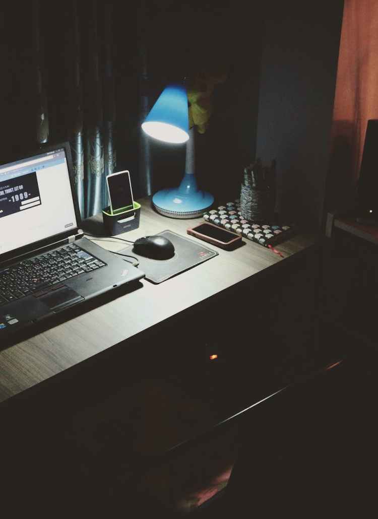 black laptop beside black computer mouse inside room