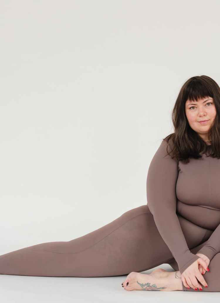 overweight woman in activewear sitting in studio during training