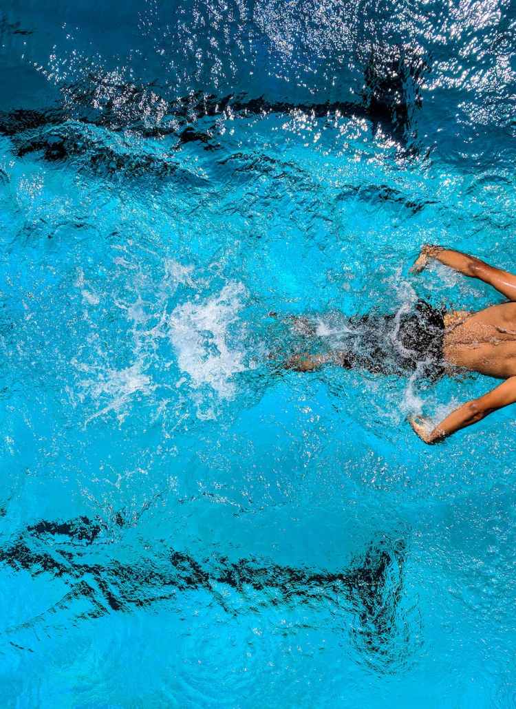 person swimming on body of water