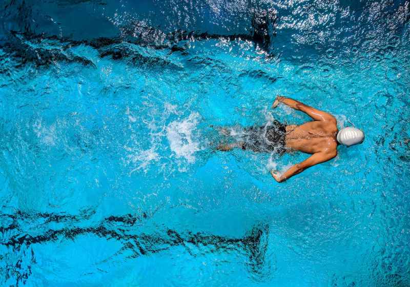 person swimming on body of water