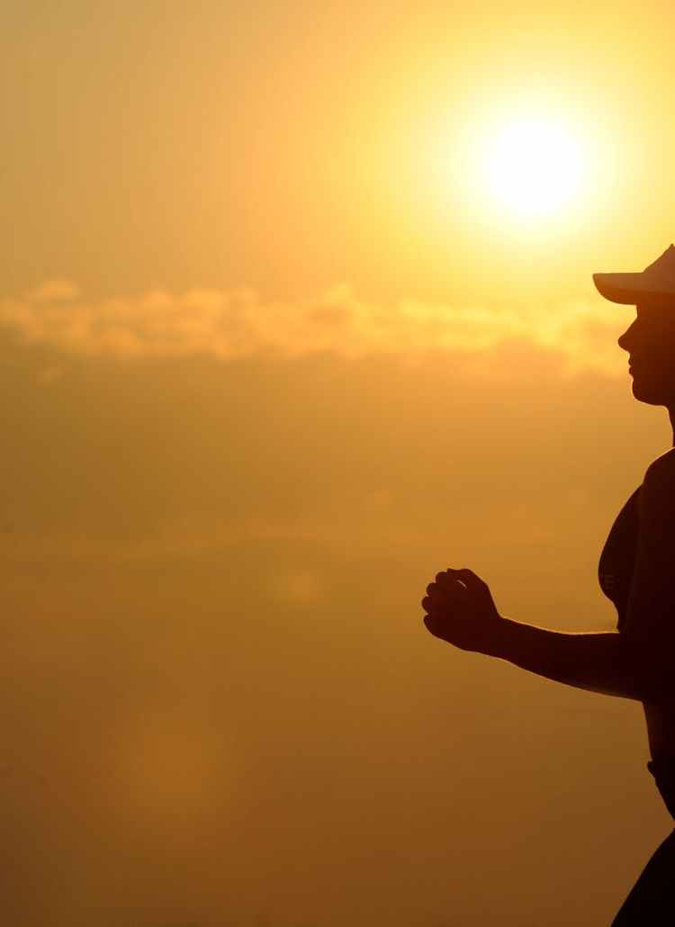 woman with white sunvisor running