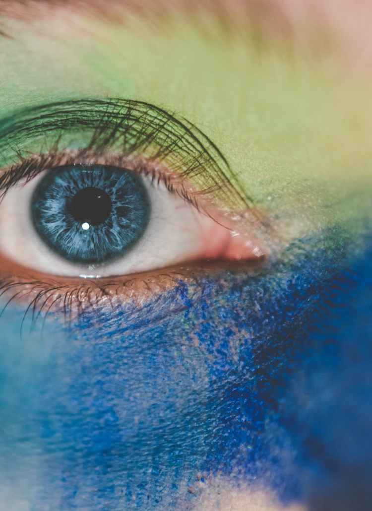 human eye with blue and green makeup
