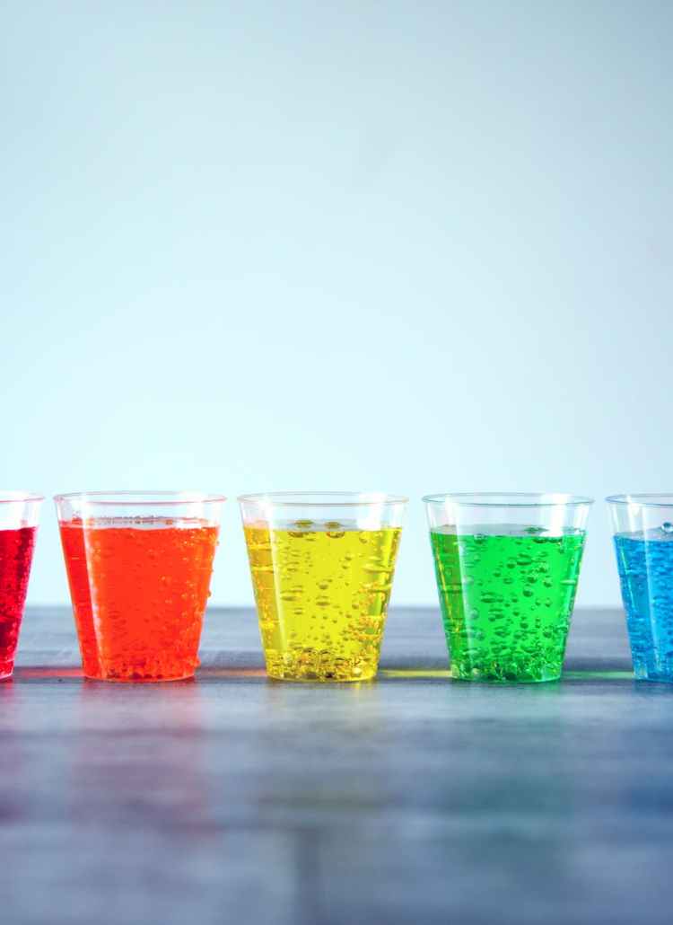 five assorted color rock s glasses on gray surface
