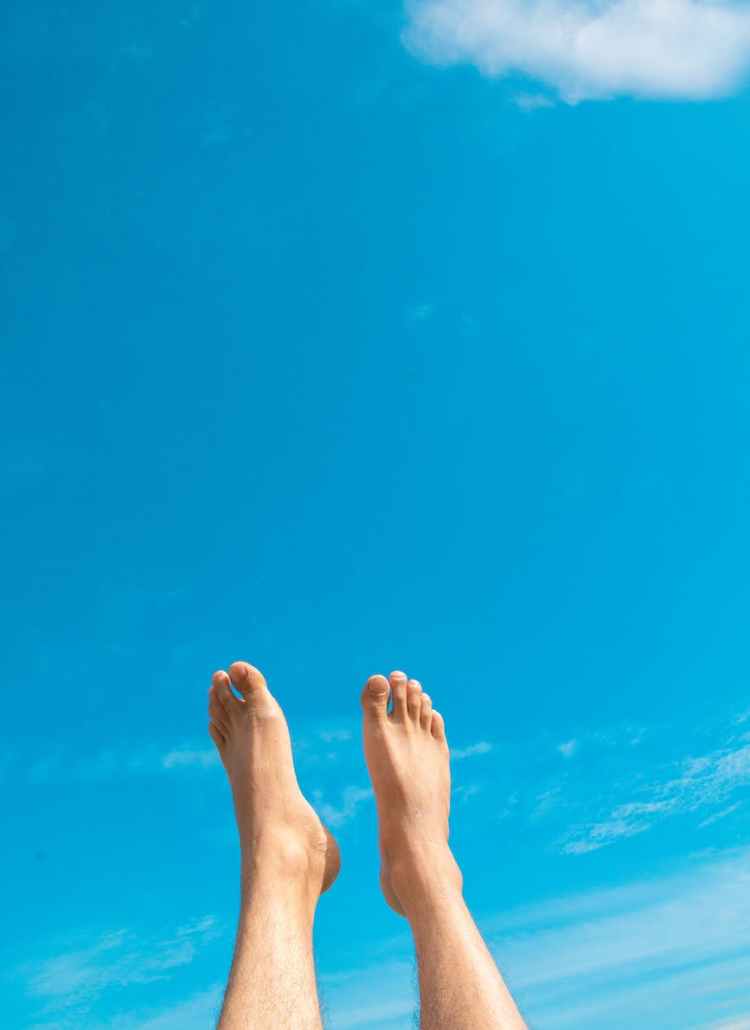 closeup photo of person s feet in the air