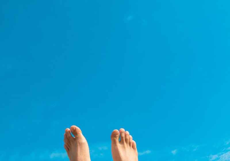 closeup photo of person s feet in the air
