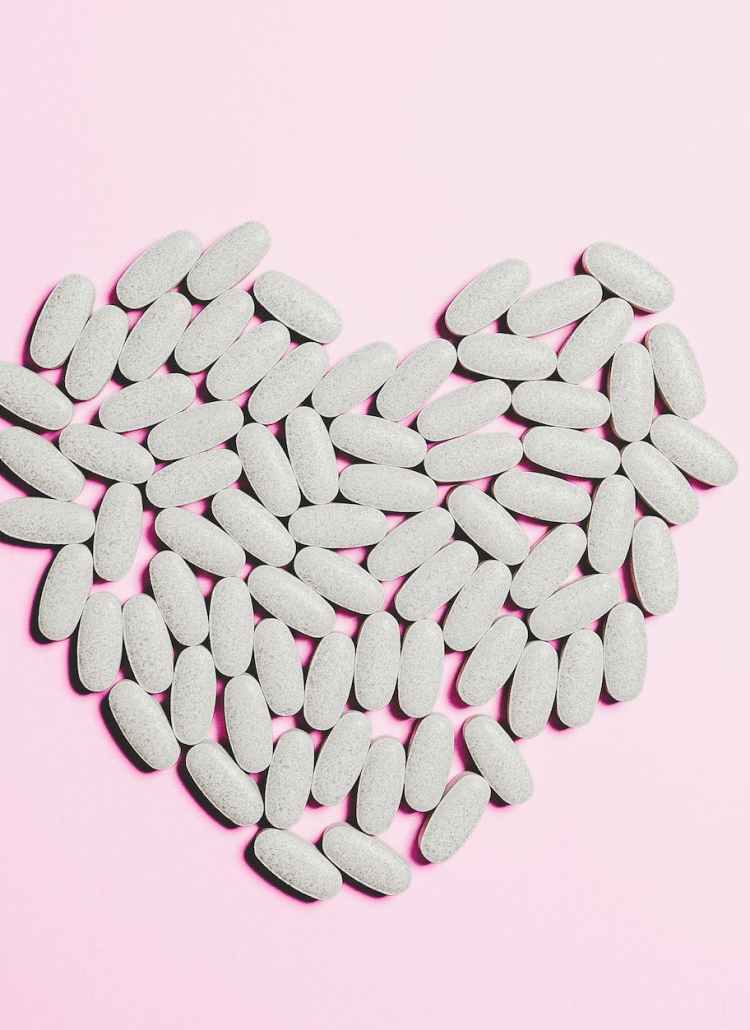 blue medicine pills on heart shape