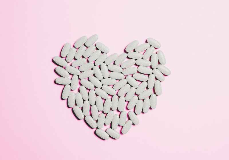 blue medicine pills on heart shape