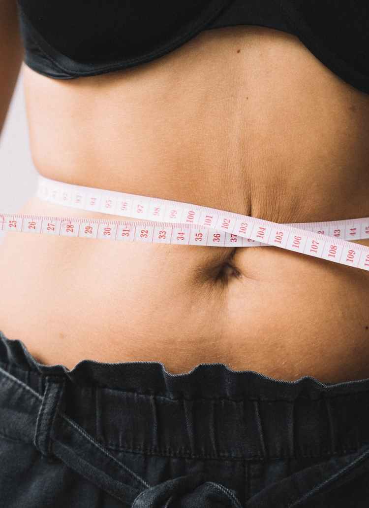 photo of a tape measure on a person s waist