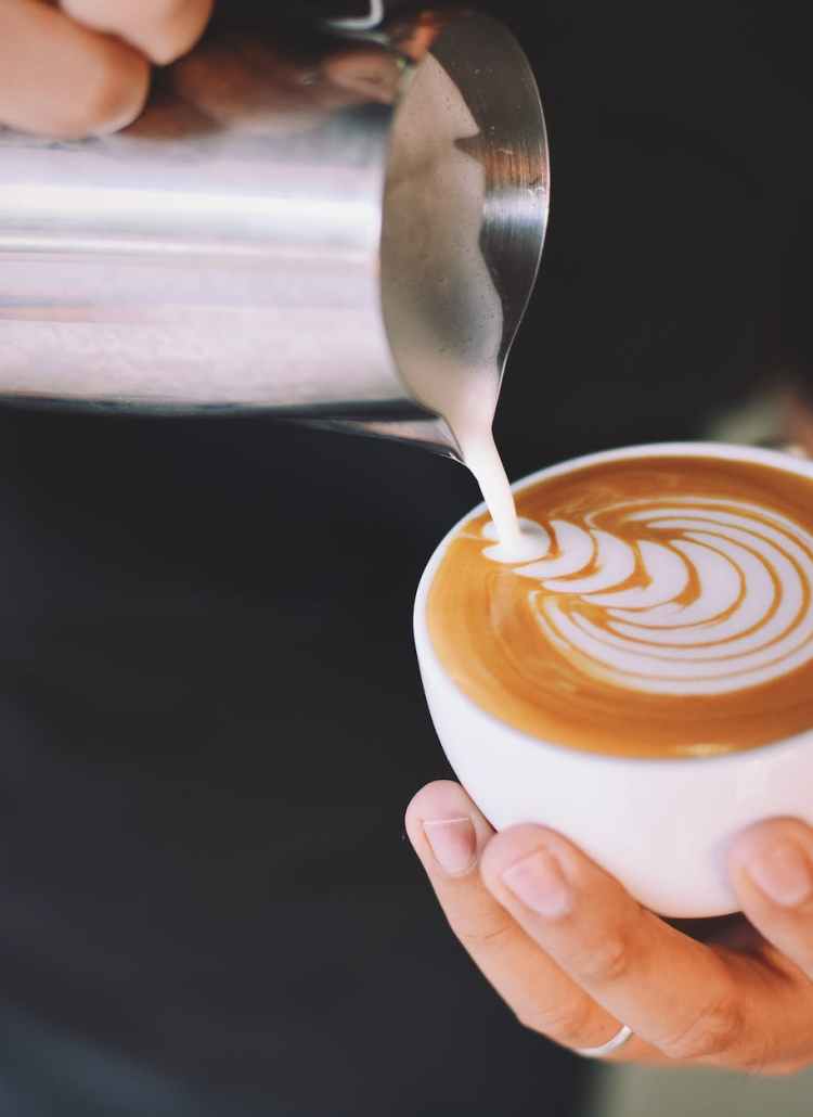 person holding white cup