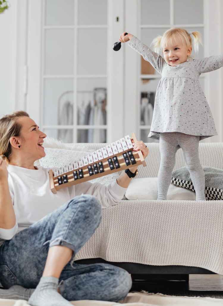 mother and daughter having fun and playing instruments