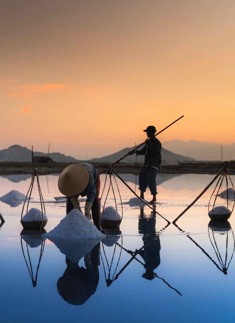 photo of people collecting sea salt
