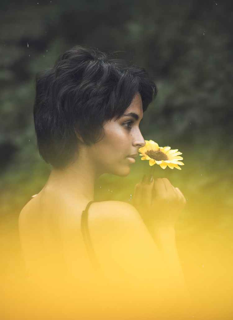 woman holding a flower