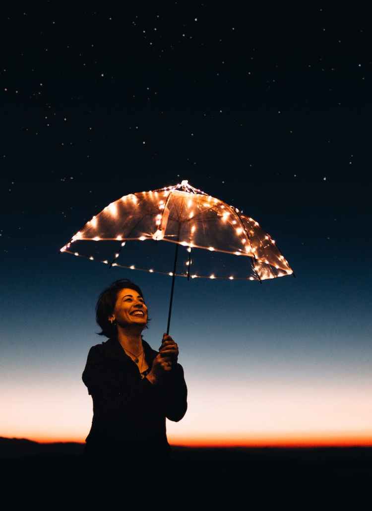 woman using umbrella with lights