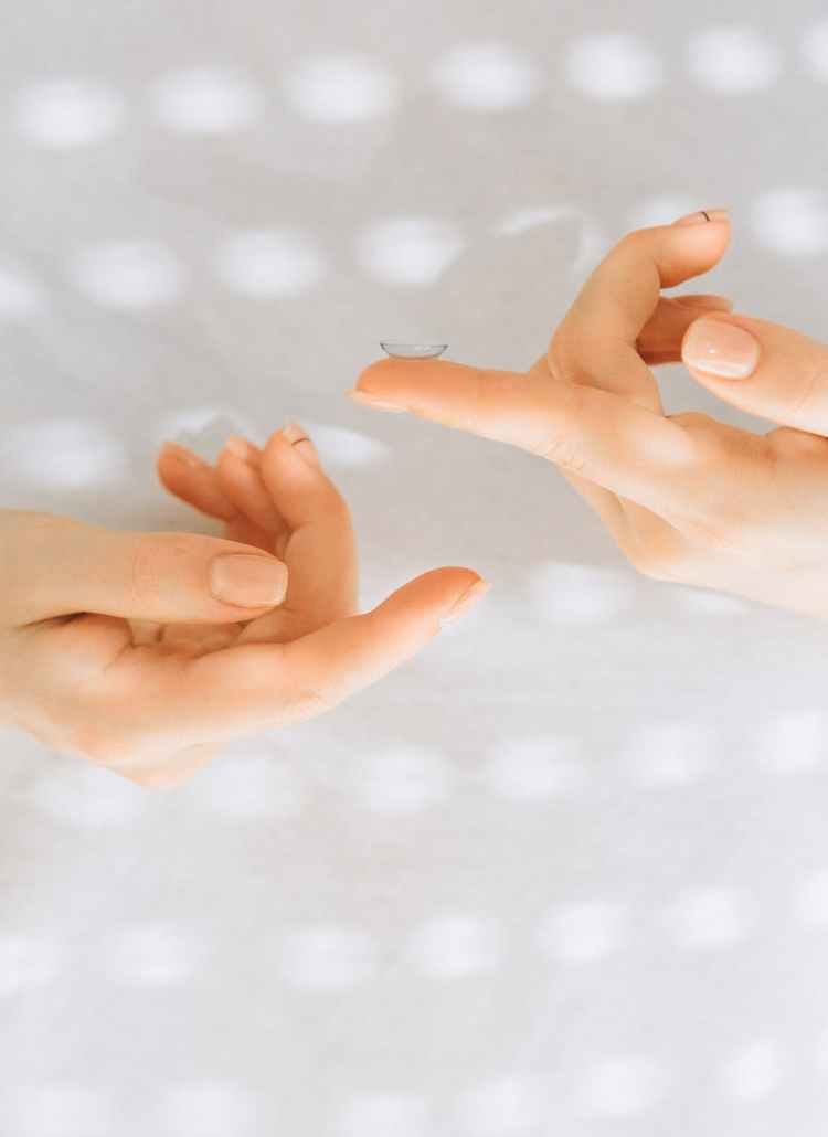 a person holding a contact lens