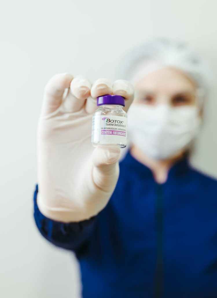 woman holding botox flask