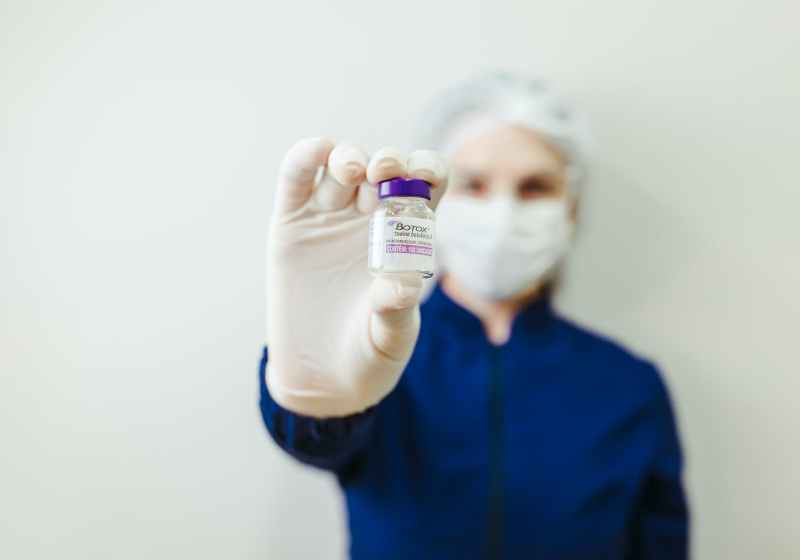 woman holding botox flask