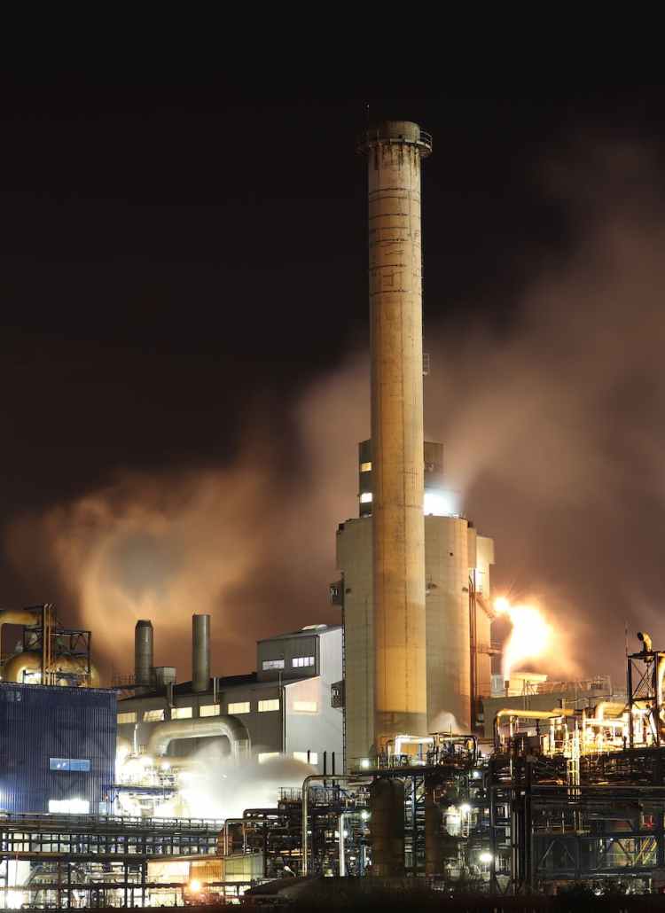 brown and white factory building during night time